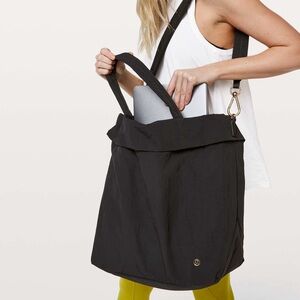 Lululemon On My Level Tote Bag in black nylon with gold-tone hardware